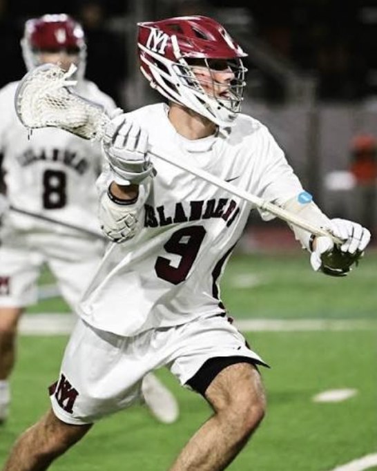 Eliot Abramson carrying the ball upfield during a game.