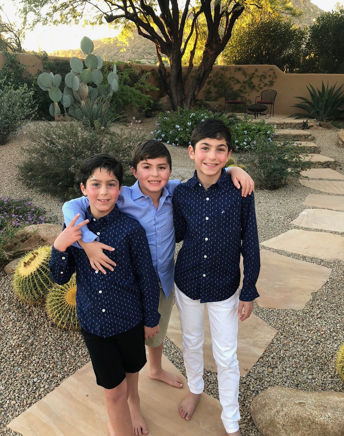 Eliot Abramson as a boy with two other boys in a desert garden.
