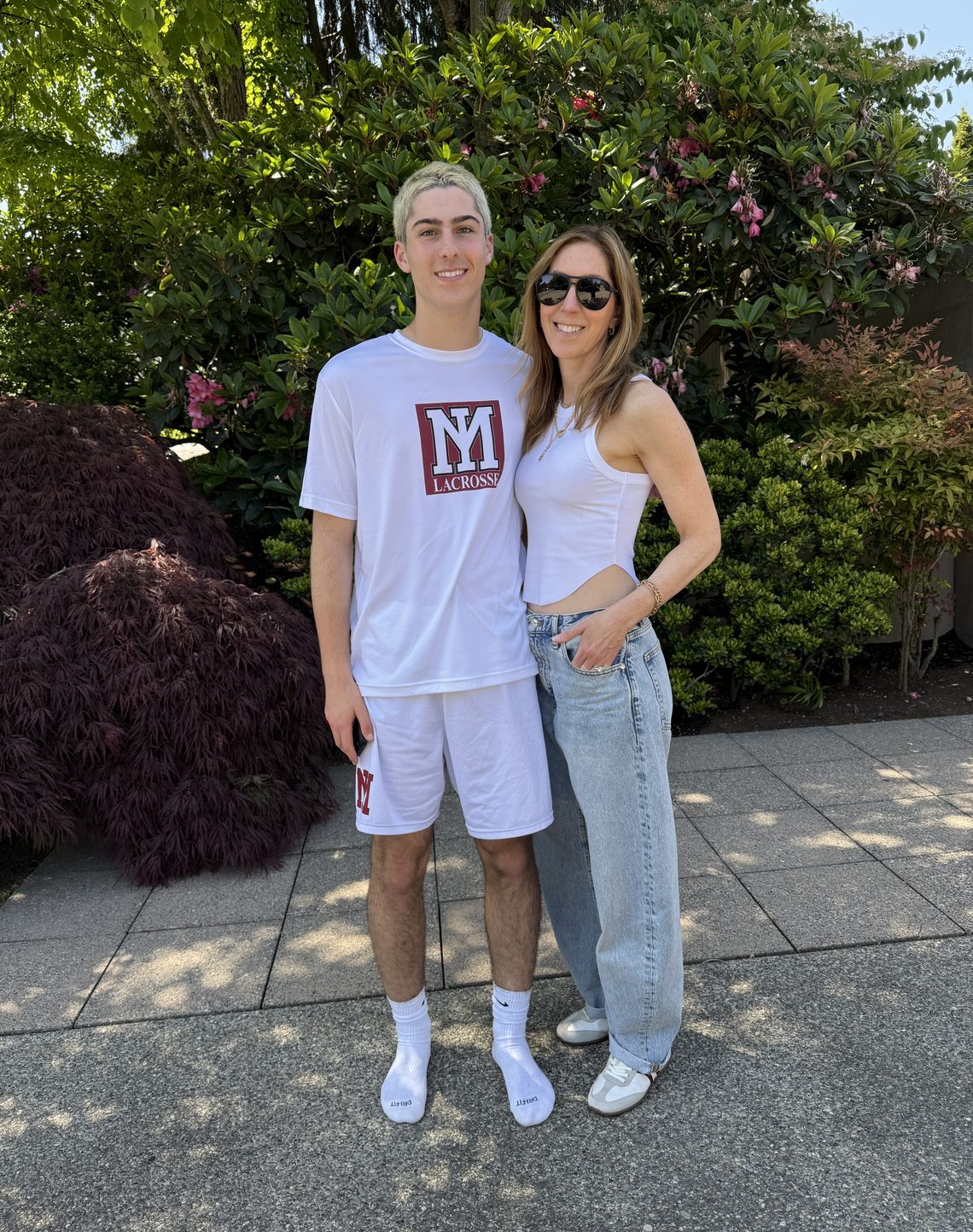Eliot Abramson in a lacrosse shirt with a family member.