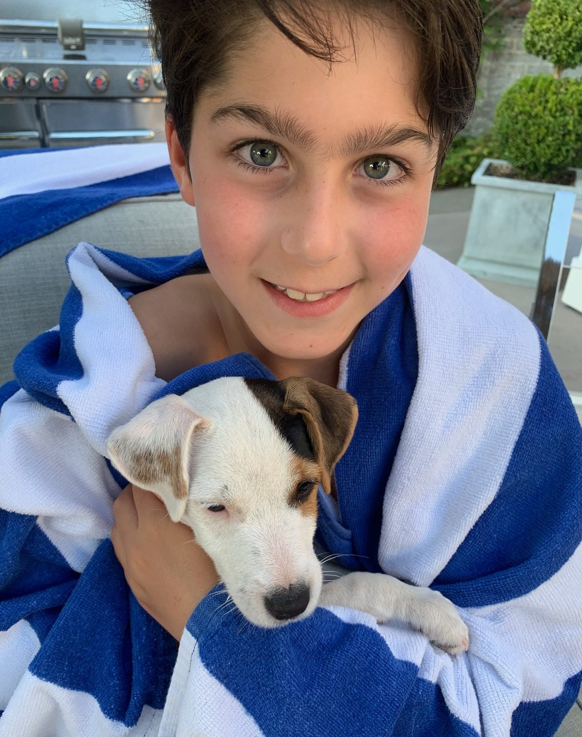 Eliot Abramson as a boy holding a puppy.