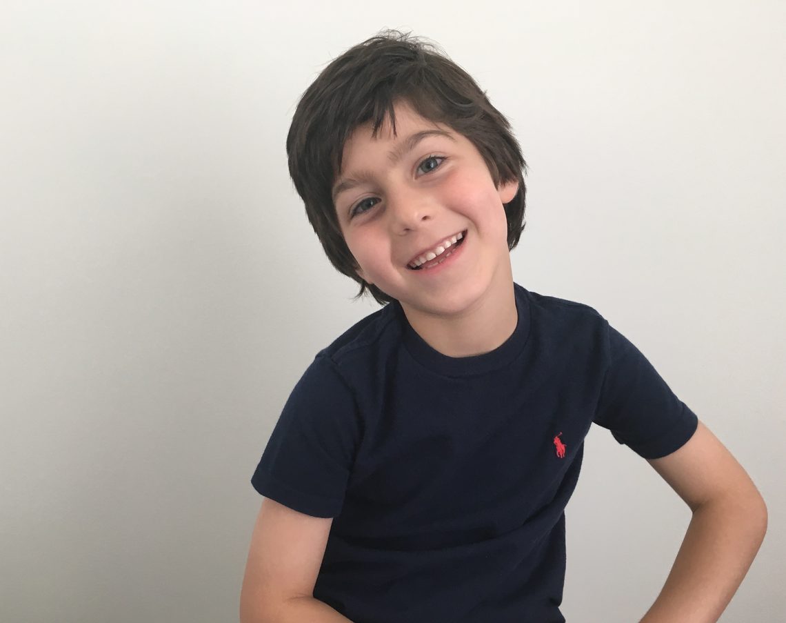 Eliot Abramson as a young boy, smiling.