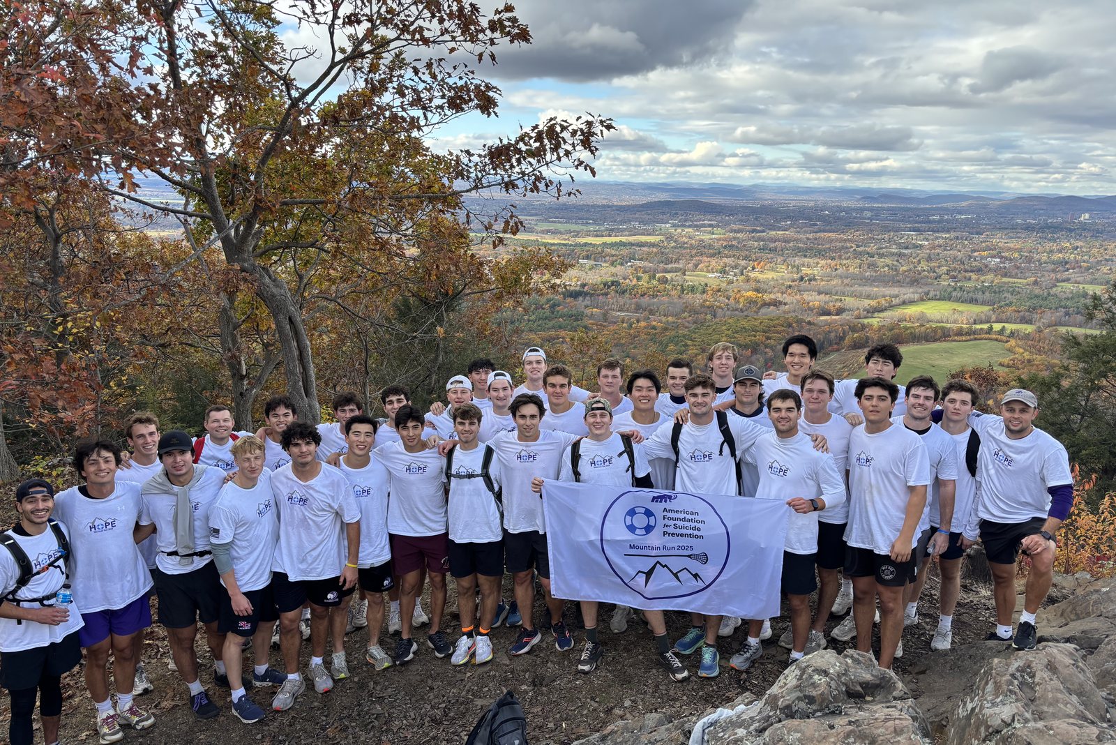 The Amherst College Men's Lacrosse team together on the ridge during the Mountain Run.